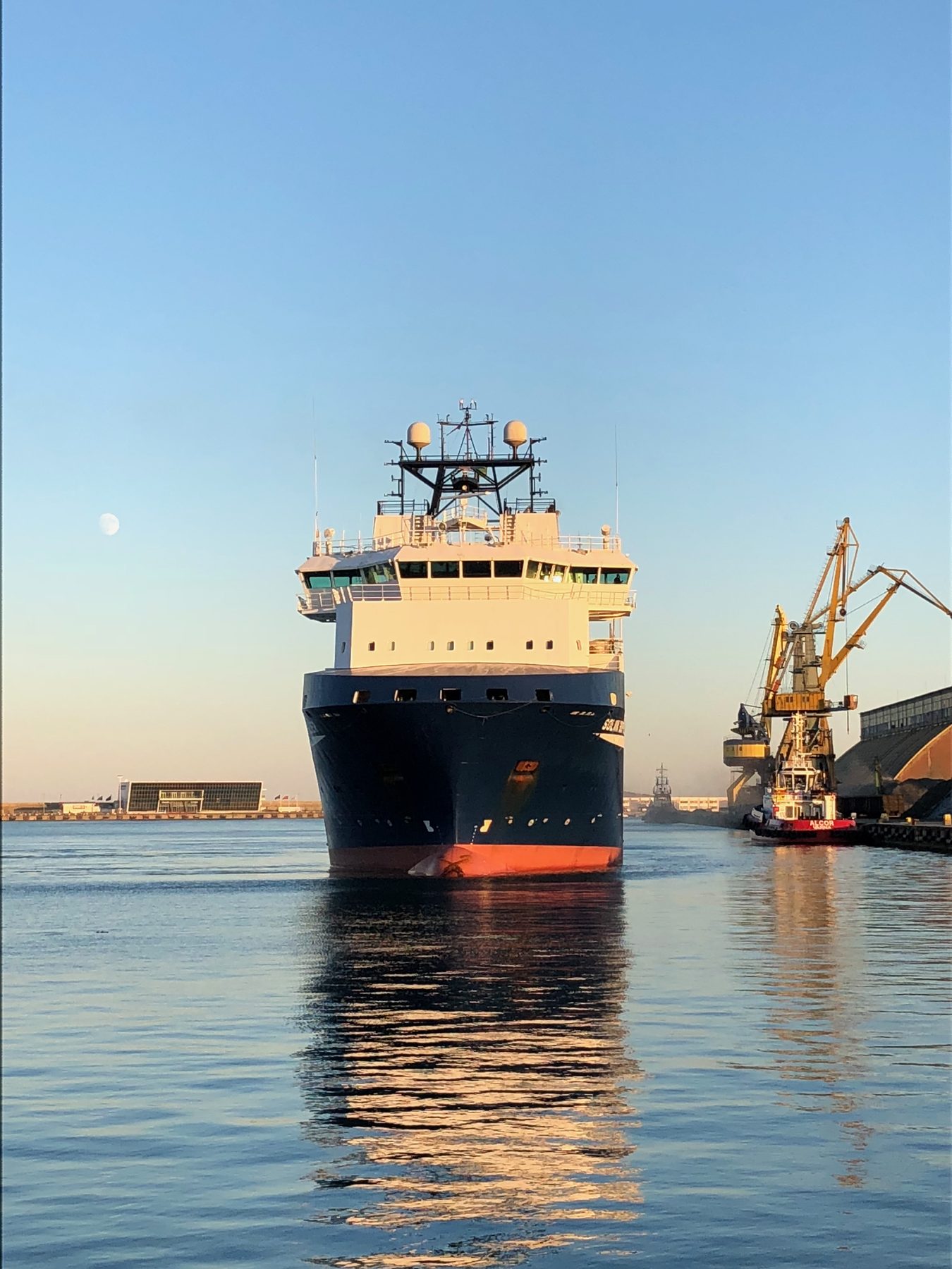 Offshore supply vessel head-on at golden hour